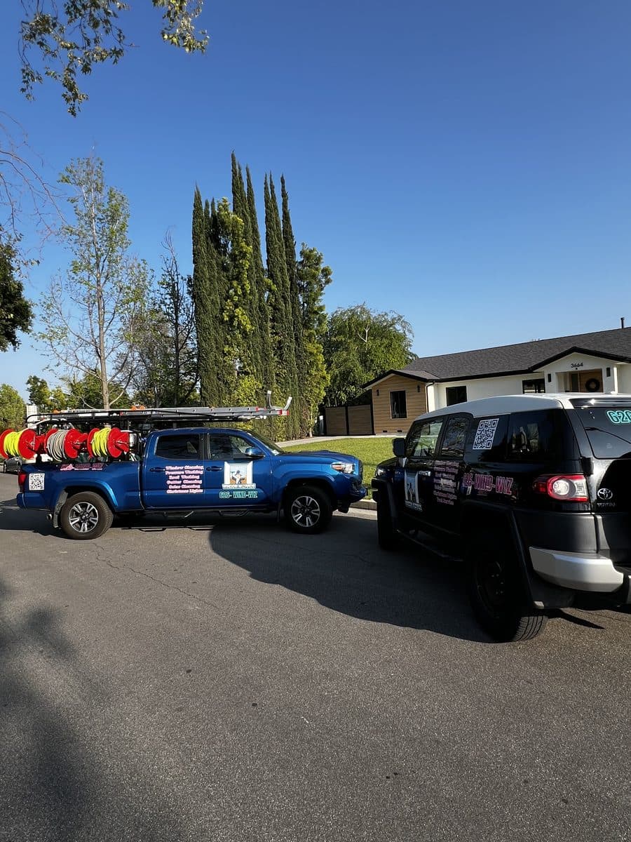 The Window Wizards branded fleet parked outside a Los Angeles home ready for a job