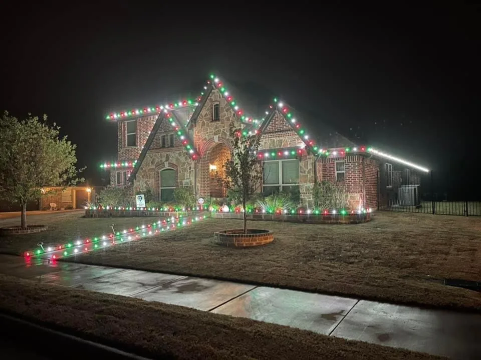 Stone home with red, green and white C9 Christmas lights installed by 626 Christmas